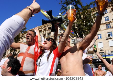 KIEV, UKRAINE - JUNE 24: English men and women drink beer in Fan-Zone of Euro 2012 on June 24, 2012 in Kiev, Ukraine. The slogan of EURO 2012 Football Championship is \