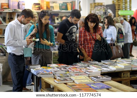 KIEV, UKRAINE - OCT 7: People choose the books at the Second International Festival BOOK ARSENAL on October 7, 2012 in Kiev, Ukraine. The guests of the fair were Alessandro Baricco & Josef Winkler.
