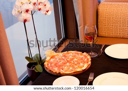 Pizza and glass of wine in a restaurant