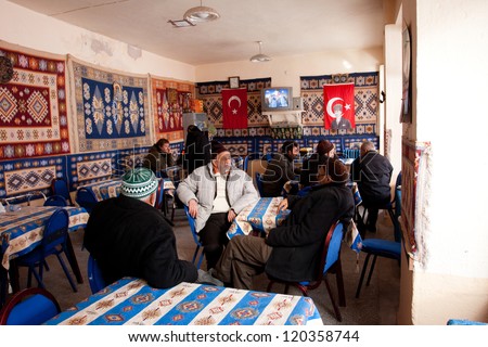 GOREME, TURKEY - CIRCA JANUARY 2012 : Seniors talk in a traditional tea house in Goreme, Turkey circa January 2012. Turkey had the highest per capita tea consumption in the world, at 2.5 kg per person