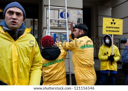 KIEV, UKRAINE - JAN 7: Greenpeace activists in radiation protection suits urges bank EBRD not to loan to Ukraine for building new nuclear reactors in Rivne & Khmelnytsky on January 7, 2012 in Kiev