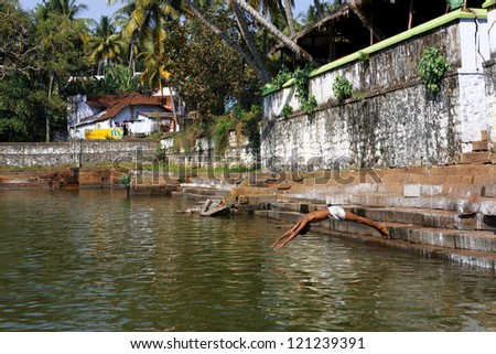 VARKALA, INDIA - JAN 10; Unidentified man jumps into the pool near the Hindu temple on January 10 2009 in Varkala India. The only place in Kerala where cliffs are found adjacent to the Arabian Sea