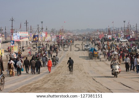 SANGAM, INDIA - JAN 27: Many people go through the giant camp area during the biggest festival in the world - Kumbh Mela, on January 27 2013 in Allahabad India. Mela 2013 will take 130 000000 visitors