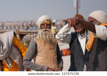 ALLAHABAD, INDIA - JANUARY 26: Elderly indian pilgrims choose the way to Sangam during the hindu festival Kumbh Mela on January 26 2013 in Allahabad India. In 2013 Kumbh Mela taking 130 000 000 people