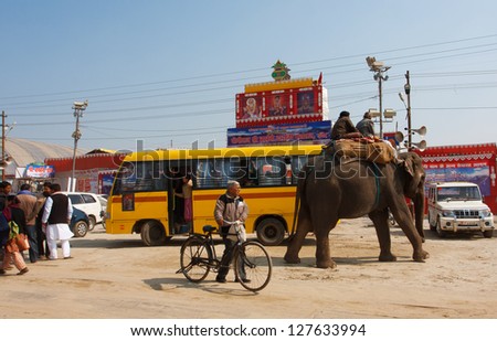 ALLAHABAD, INDIA - JAN 25: Elephant and the indian people on the bus stop of biggest festival in the world - Kumbh Mela, on January 25 2013 in Allahabad India. Mela 2013 will take 130 000 000 visitors
