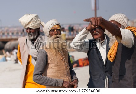 ALLAHABAD, INDIA - JAN 29: Elderly indian men have emotional conversation during the celebration Kumbh Mela, on January 29, 2013 in Allahabad, India. Fest Kumbh Mela 2013 will take 130 000000 visitors