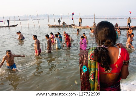 ALLAHABAD, INDIA - JAN 27: Indian women and men stand in the cold Sangam water at time of celebration Paush Purnima during the biggest hindu festival Kumbh Mela on January 27, 2013 in Allahabad, India