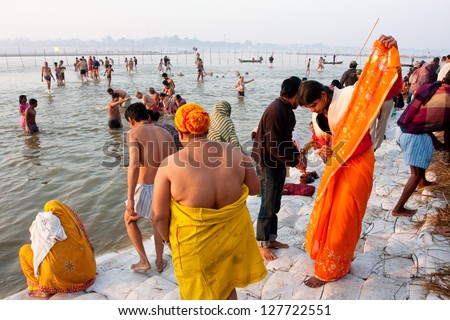 ALLAHABAD, INDIA - JAN 27: Indian women wears a sari after bathing in holy water of Sangam during the biggest festival in the world, Kumbh Mela on January 27, 2013 in Allahabad, India