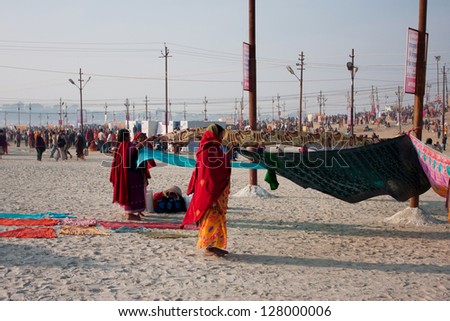 ALLAHABAD, INDIA - JAN 30: Women dry sari outdoor after bathe in Sangam during the biggest event in the world, Kumbh Mela on January 30 2013 in Allahabad India. Mela \'13 will take 130 000000 visitors