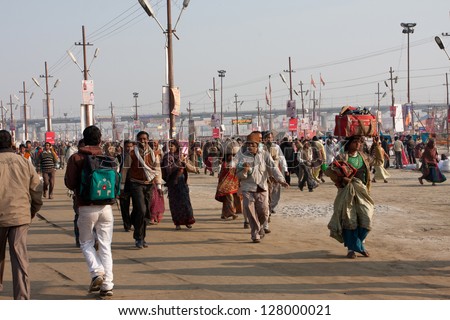 ALLAHABAD, INDIA - JANUARY 30: Happy hindu people rush in the area of the biggest festival in the world - Kumbh Mela, on January 30, 2013 in Allahabad India. Mela \'13 will take 130 000000 visitors