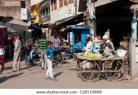 LUCKNOW, INDIA - DEC 19: Traditional seller of guava fruits on the crowded street at the sunny day on December 19, 2012 in Lucknow, India.  Lucknow in Uttar Pradesh state has population of 4,588,455