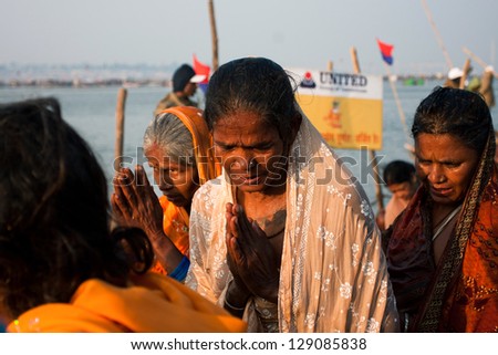ALLAHABAD, INDIA - JAN 27: Elderly indian women prays in the crowd of people at the biggest event on Earth, Kumbh Mela on January 27, 2013 in Allahabad, India. Mela \'13 will take 130 000000 visitors