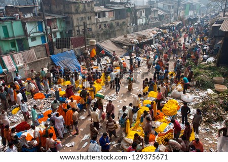 KOLKATA, INDIA - JAN 11: People move through giant Mullik Ghat Flower Market on January 11, 2013. The market is more than 125 years old. More than 2000 sellers work in the market every day