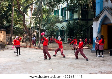 KOLKATA, INDIA - JAN 17: Unidentified school children play frisbee outdoor on January 17 2012 in Kolkata, West Bengal, India. West Bengal state has 18 universities & 136 affiliated colleges