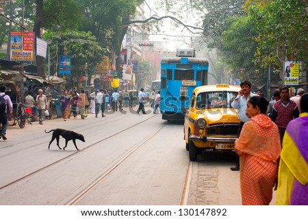 KOLKATA, INDIA - JAN 20: Transport and human traffic on busy asian street on January 20, 2012. Kolkata\'s \