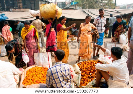 KOLKATA, INDIA - JAN 13: Asian woman quarrel with the seller of flowers on the crowd market street on January 13, 2012 in Kolkata. Only 0.81% of the Kolkata\'s workforce employed in agriculture sector