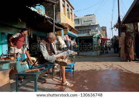 CHITRAKOOT, INDIA - DEC 29: Elderly man read a newspaper outdoors on December 29, 2012 in Chitrakoot, India. Chitrakoot has an average literacy rate of 50%, lower than the national average of 59.5%