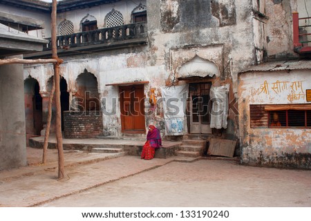 UTTAR PRADESH, INDIA - JAN 27: Elderly Indian woman sits alone inside the yard of historical building on January 27 2013 in Ayodhya, India. Uttar Pradesh is the 5th largest state, with 200 mill.people