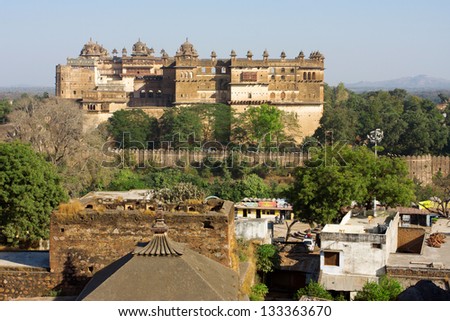 ORCHHA, INDIA - DEC 20: View of the historical Jahangir Mahal and indian town Orchha on December 20, 2012 in Orchha, India. Most finest examples of classical Mughal Architecture was completed in 1598