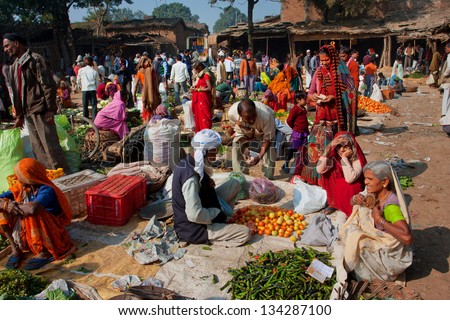 CHITRAKOOT, INDIA - DEC 29: Women buy fresh vegetables on the colorful market on December 29 2012 in Chitrakoot, India. India\'s arable land area of 159.7 mill.hectares is the 2nd largest in the world