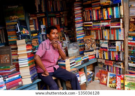 KOLKATA, INDIA - JAN 15: Seller of the books waiting for the visitors on the outdoor book market on January 15, 2012 in Kolkata. From 1976 Kolkata have the Book Fair with 2 million visitors annual