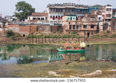 CHITRAKOOT, INDIA - DEC 29: Big boat loaded with people floating in the Indian river on December 29 2012 in Chitrakoot India. Population of Chitrakoot is 22,294. By the legend, Lord Rama lived here