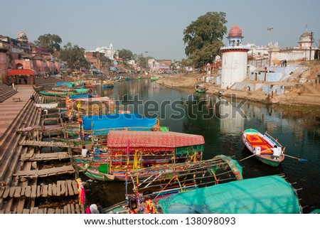 MADHYA PRADESH, INDIA - DEC 30: River dock with the boats waiting for passengers on December 30, 2012 in Chitrakoot India. Population of Chitrakoot is 22,294 people. By the legend Lord Rama lived here