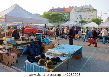 VIENNA, AUSTRIA - JUNE 7: Sellers of second hand items laid out goods in the early morning on the famous market Naschmarkt on JUNE 7, 2013. The Naschmarkt has existed since the 16th century.