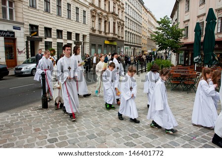 VIENNA - MAY 29: Unidentified children and the priests go to the service of the Catholic Church on May 29, 2013 in Vienna, Austria. Catholics are 64.8% of the austrian population & Lutherans are 3.8%