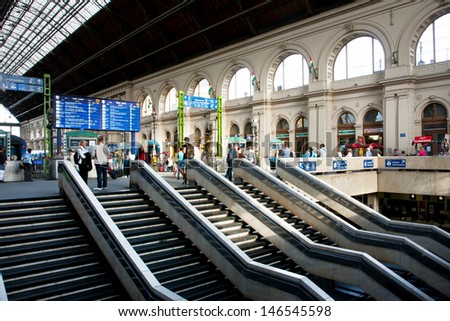 BUDAPEST - MAY 29: Many passengers walk inside Keleti railway station at the sunny day on 29 May 2013 in Budapest, Hungary. The main international railway terminal in Budapest was constructed in 1884