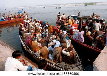 VARANASI, INDIA - JANUARY 2: A lot of people sit on the crowded boats to cross the Ganges River on January 2, 2013. The 2,525 km river rises in the western Himalayas & flows through the Gangetic Plain