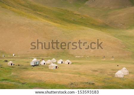 AT BASHI, KYRGYZSTAN - AUG 7: Mountain meadow with the yurts - homes of the local nomadic people on August 7 2013 in At Bashi, Kyrgyzstan. Kyrgyzstan\'s population is 5.2 million. The country is rural