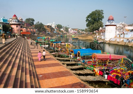 CHITRAKOOT, INDIA - DEC 30: Colorful boats wait for the passengers at the river docks of indian city on December 30, 2012. Population of Chitrakoot is 22,294. By the legend Lord Rama lived in the city