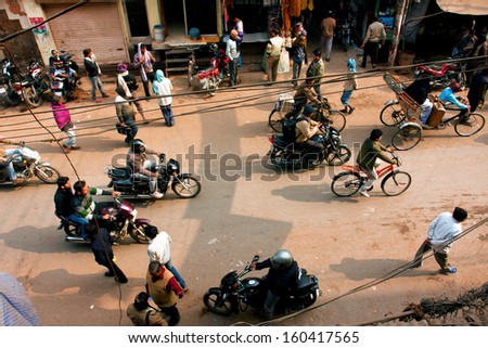 VARANASI, INDIA - JAN 4: Chaotic traffic of vehicles and pedestrians on the street on January 4, 2013 in ancient indian city Varanasi. Varanasi urban agglomeration has a population 1,5 million people