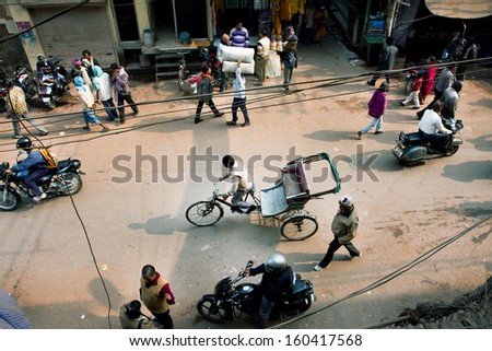 VARANASI, INDIA - JAN 4: View from the height of the traffic and the people on Indian streets on January 4, 2013 in ancient indian city. Varanasi urban agglomeration has a population 1,5 million