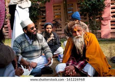 BODHGAYA, INDIA - JAN 8: Muslim group talk with the elderly hindu man about religion on January 8 2013 in Bodhgaya. It is a place of pilgrimage. Siddhartha Gautama attained enlightenment here at 500BC