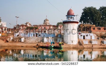 CHITRAKOOT, INDIA - DEC 30: River boats moored to the old indian city ghat with historical buildings on December 30, 2012. Population of Chitrakoot is 22,294. By the legend Lord Rama lived in the city
