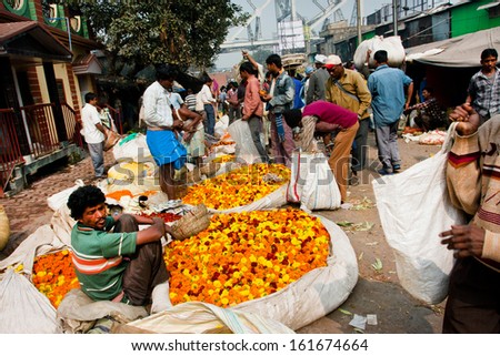 KOLKATA, INDIA - JAN 13: Indian traders sell the big baskets of the flowers in market on January 13, 2012 in Kolkata. Only 0.81% of the Kolkata\'s workforce employed in the primary sector (agriculture)