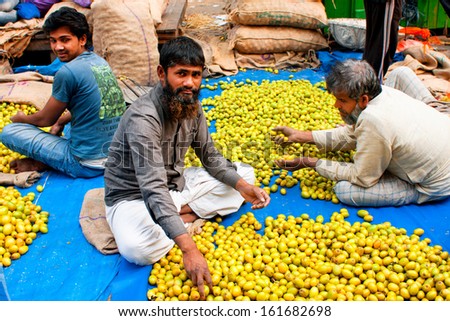 KOLKATA, INDIA - JAN 13: Bearded muslim fruits trader work on the street market on January 13, 2012 in Kolkata. Only 0.81% of the Kolkata\'s workforce employed in the primary sector (agriculture)