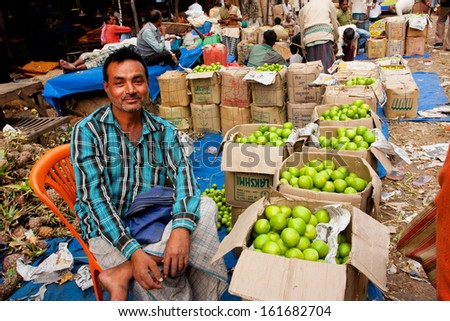 KOLKATA, INDIA - JAN 16: Friendly fruits dealer sell exotic fruits on the colorful city market on January 16, 2012, in Kolkata. Only 0.81% of the Kolkata\'s workforce employed in the agriculture.