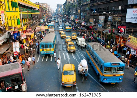 KOLKATA, INDIA - JAN 20: Lines of the yellow Ambassador taxi cabs and buses on the road of the city on January 20, 2013 in Calcutta, India. Kolkata has a density of 814.80 vehicles per km road length