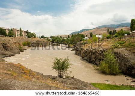 Dirty water of the river Naryn in Kyrgyzstan, Central Asia.