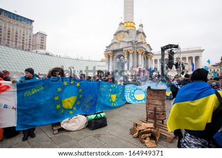 KIEV, UKRAINE - NOV 28: Demonstrators of ukrainian Euromaidan movement stand with EU flags and demand for the signing the documents of Accession to the European Union on November 28, 2013 in Kiev.