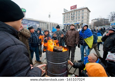KYIV, UKRAINE - NOV 28: Fire on the cold main Maidan square with people occupying it and require government to sign documents of Accession to the European Union on November 28, 2013 in Kiev, Ukraine.