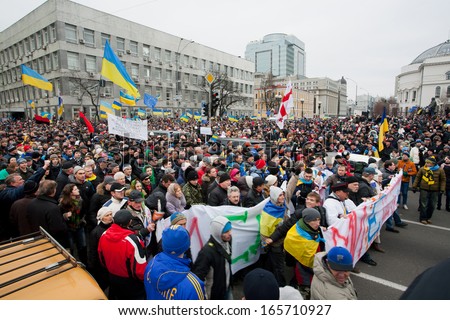 KYIV, UKRAINE - DEC 1: Huge crowd of men and women with different anti-government bunners walking down the street during the pro-European protest on December 1, 2013 in Kiev, Ukraine