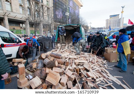 KYIV, UKRAINE - DEC 1: People harvest wood for fires, occupying main Maidan square for anti-government demonstration during the pro-European protest on December 1, 2013 in Kiev, Ukraine