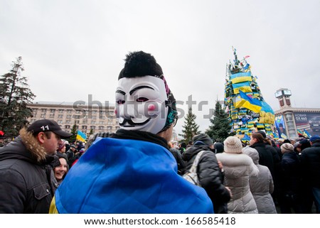 KYIV, UKRAINE - DEC 8: Protester with Guy Fawkes mask in the crowd of people on the occupying street during two weeks anti-government protest on December 8, 2013, in Kiev, Ukraine.