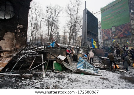 KYIV, UKRAINE - JAN 21: Police Force stand behind burned barricades built by crowd of people on the occupying street during anti-government protest Euromaidan on January 21, 2014, in Kiev, Ukraine.
