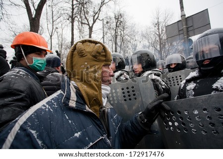 KIEV, UKRAINE - JAN 21: Angry protester in a military helmet arguing with policemen in government quarter during winter anti-government protest Euromaidan on January 21, 2014, in Kyiv, Ukraine.