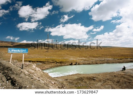 KYRGYZSTAN, CENTRAL ASIA  - AUG 4: Old man and two boys fishing in a river at an altitude of 4000 meters on August 4, 2013 in Kyrgyzstan. Kyrgyzstan\'s population is 5.4 million, 34% are younger age 15